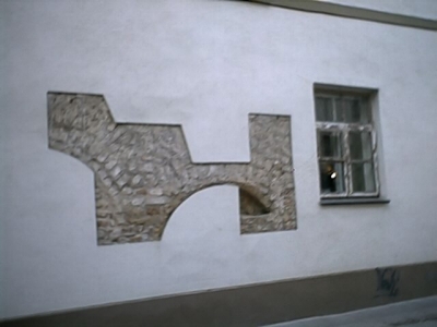 Exposed Stone under Restored Stucco